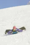 Valley resident Sydney Stewart, 15, takes advantage of spring
break, blue skies and warm temperatures as she rockets down the
sledding hill at Hatcher Pass Thursday afternoon. Stewart is usin