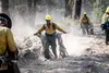 Oregon Army National Guard Citizen-Soldeir Pfc. Andres Moreno, along with his teammates, recover more than a mile of fire hose during mop up operations on the Two Four Two Fire, Chiloquin, Or