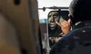 Spc. Brandon Charles Brown, an infantryman assigned to 4th Battalion, 9th Infantry Regiment,1st Stryker Brigade Combat Team, 4th Infantry Division, applies camouflage paint onto his face duri