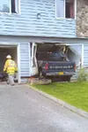 Photo courtesy Patrick Brown A Chevrolet truck is parked halfway
inside the wall of a residence on West Nelson Avenue in Wasilla
Wednesday evening.