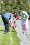 ROBERT DeBERRY/Frontiersman Joe and Mary Ann Lisenby line the
streets of the Mountain Rose subdivision in Palmer with American
flags in remembrance of the Sept. 11, 2001 terrorist attacks. Th