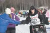 Dallas Seavey gives fives to spectators gathered along the trail in Willow during the restart of the 2011 Iditarod Trail Sled Dog Race. Seavey won last year’s race in record time. Frontiersma