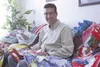 HEATHER A. RESZ/Frontiersman Dr. John D. Boston with an
assortment of quilts his patients in Alaska made to give to his
patients in Mongolia, where he works with the Alaska Air National
Guard