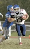 ROBERT DeBERRY/Frontiersman Hayden Niekamp tries to tackle North
Pole’s Tayvon Snelling. Robert DeBerry