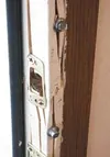 Business owner Nathan Evans used bolts to secure the shattered
doorframe to his office at Auto Body Concepts. Photo by MARY
SPEARS/Frontiersman.