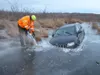 Daniel Russell of Alaska Low Range Recovery uses a chain saw to cut a Jeep from the ice in the Palmer Hay Flats on Jan. 10. At least two vehicles have gotten stuck in the ice this winter. Cou