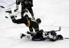 Colony defenseman Kolten Ketchum falls on Chugiak forward Grant Epple as both reach up to grab a loose puck in the air during Chugiak's 5-1 semifinal win over Colony on the second day of the 