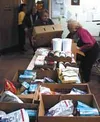 Volunteers from the Wasilla Senior Campus work to move food
donated by the USDA into boxes for distribution to the public.
Photo by DANIEL SPOTH/Frontiersman.