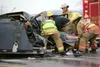 (ROBERT DeBERRY/Frontiersman) Members of the Mat-Su Central Fire
Department remove the passenger in a second car that was involved
in an accident at the intersection of the Palmer-Wasilla Hig