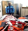 AST Captain Tony April sorts 20 winter jackets for Butte Elementary School students. Courtesy photo.