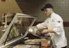 Airman Steven Hoffman, 673d Force Support Squadron food service journeyman, prepares lunch at the Iditarod Dining Facility on Joint Base Elmendorf-Richardson, Alaska, Aug. 29, 2017. The dinin