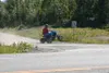 A young ATV rider travels along a dirt trail near Trunk Road.
Recent ATV collisions have occurred when the ATVs crossed driveways
just as vehicles were entering or exiting. Photo by JOEL
DAVI