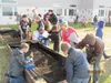 About 450 student body, parents and teachers use shovels, buckets and wheelbarrows to move piles of topsoil into the school’s new garden beds during Machetanz Elementary School’s Garden Dirt 