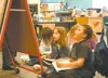 Larson Elementary School Spanish immersion students Gabrielle
Richie, center, and Savion Stallworth work to decipher a paragraph
written in Spanish. JOEL DAVIDSON/Frontiersman
