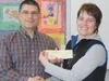 Brian Porcello accepts a check for $100 from Mat-Su Education Association Vice President Tracey Martin. Courtesy photo
