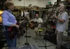 From left to right, No Wake members Michelle LaRose, Sean Wake and Pat Wake rehearse in Pat Wake’s shop near the Matanuska River in the Butte on Friday. The band is slated to play during the 