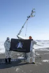 Two Space Force Guardians hold a flag during an exercise above the Arctic Circle, April 15, 2020.