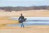 A golfer makes his way past a frozen water hazard at Fishhook
Golf Course Monday afternoon. All nine hole are playable as well as
the driving range. The course is open from 10 a.m. until earl
