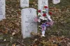 U.S. Sen. Mark Begich and his wife, Deborah Bonito, place a
wreath at the grave of Wasilla High graduate Ronald John Hemenway
at Arlington National Cemetery on Veterans Day. ET1 Hemenway died