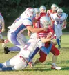 CASEY RESSLER/For the Frontiersman Wasilla senior Mike Chafin is
stopped by a pair of Patriots during a 28-14 loss to North Pole at
Wasilla’s Veterans Memorial Field on Friday. The Warriors d