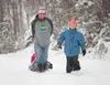 Ben Schaafsma and son, Ruben, walk through fresh snow on the bike trail along the Palmer-Wasilla Highway Monday afternoon. Riding in the sled is Schaafsma’s daughter, Bree. Parts of the Valle