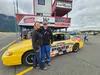 Michelle Lackey Maynor poses for a photo with her father Earl Lackey in front of his iconic yellow Alaska Raceway Park race car. Jacob Mann/Frontiersman