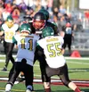 Houston running back Ben Pelesasa runs into a pair of Seward Seahawks during a 45-12 win Aug. 22 at Houston High School. Pelesasa finished with 125 yards and two touchdowns in the victory. Pe