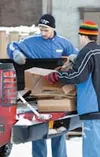 Daniel Brown and Ethan Graddick haul cardboard from the back of
a pickup Saturday. Photo by RINDI WHITE/Frontiersman.