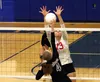 Wasilla’s Jada Schultz reaches for the block as Palmer’s Deana McNutt pushes the ball over the net during Wasilla’s 3-2 win over the Moose Tuesday at Palmer High School. Jeremiah Bartz/Fronit