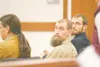 ROBERT DeBERRY/Frontiersman Christopher Erin Rogers, center,
watches as a potential juror is escorted into the courtroom
Thursday morning in Palmer.