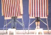 ROBERT DeBERRY/Frontiersman Two small voters from Cottonwood
Creek Elementary use step stools while voting in a mock
presidential election at the school Monday morning.