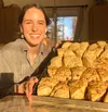 Delaney Peters, owner/operator of central Mat-Su microbakery Delaney’s Sourdough, shows off a tray of her fresh-baked scones. A variety of her all-sourdough, all-organic baked goods are now a