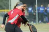 Wasilla third baseman Hannah Zwolinski hugs pitcher Deborah Polk after Zwolinski caught a line-drive during the Warriors' season-opening win over Palmer on April 20, 2016, at the Alcantra Spo