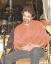 (Photo by Laurie Green) Looking very pleased is Eric Deeter at
Vagabond Blues, during the reading of a podcast script he wrote for
a Radio Free Palmer fund-raiser.