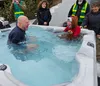 Jason Camis and his daughter Luciana warm up in a hot tub after taking the plunge. Jacob Mann/Frontiersman