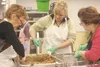 Christmas Friendship Dinner volunteers prepare dressing as part of this year’s holiday meal, which fed an estimated 3,400 people Tuesday. CHERYL METIVA/Frontiersman
