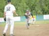 Alaska Road Warriors shortstop Zach Vance runs for third base as
Chugiak second baseman Derek Henry, fields a ground ball in the
background Saturday at Lou McManus Field in Wasilla. Chugiak s