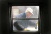 ROBERT DeBERRY/Frontiersman General contractor George Greeno
works on removing an old window so a new one can be installed in a
trailer that the Santa Cop program is renovating for a 63-year-