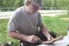 Monty Mangum works on a wood carving while at the Wasilla Art
Walk Thursday afternoon in Wasilla. (ROBERT
DeBERRY/Frontiersman)
