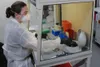 Spc. Taylor Wolik, medical laboratory specialist with the 1st Area Medical Laboratory, performs a diagnostic assay at the U.S. Army Medical Research Institute of Infectious Diseases field lab