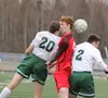 Wasilla captain Harris Fife is sandwiched between a pair of players during a 5-1 loss to Colony Tuesday at Colony High School. Jeremiah Bartz/Frontiersman