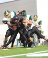 Houston's Waylon Soptick gets tackled by a pack of Seward Seahawks during Saturday's game at Houston High School. ROBERT DeBERRY/Frontiersman.com