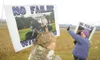 ROBERT DeBERRY/Frontiersman Wasilla's Gwen Mitchell, left, holds
a sign that reads 'No Failin' with Palin' as friend Sandy May waves
to passing traffic at a rally near the Glenn and Parks Hig