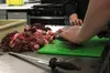 Culinary students slice strips of moose meat. Frontiersman file photo