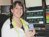 Sarah Beranek, a dispatcher with the city of Palmer, holds up the pin her supervisor awarded her Tuesday for helping deliver a baby over the phone. The dispatch center has lately assisted in 