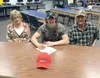 Palmer senior Chase Ferris sits with his parents, Linda and Bob, in the Palmer High School library May 2, 2016, just prior to signing his National Letter of Intent to attend the University of