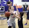 Palmer guard Abrianna Busbey drives to the basket, splitting a pair of defenders during a game against Soldotna last season. Busbey is part of a Palmer girls basketball progam that graduated 