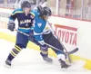 DON SEABROOK/Wenatchee World Alaska’s Jake Parenteu and
Wenatchee’s Junior Cadiz battle on the boards for the puck in
Friday night’s hockey game at Town Toyota Center in Wenatchee,
Wash. Wena