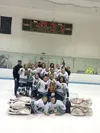 The Palmer Pioneers U14 girls comp squad celebrates a 5-4 win over the Junior Avalanche in the Bantam IV championship game of the Anchorage Hockey Association's 2015 Turkey Shootout Nov. 29 i
