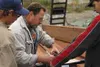 Matthew Marre, left, and cousin Casey Marre, far right, work
with Pat Hale to help construct a trellis for the Iditapark Garden
of Reflection. Photo by JOEL DAVIDSON/Frontiersman.
